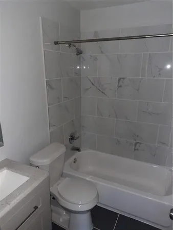 a bathroom with a toilet and a bath tub