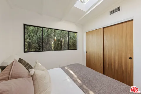 a bedroom with a bed and a window