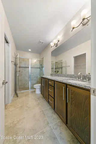 a bathroom with a glass shower door