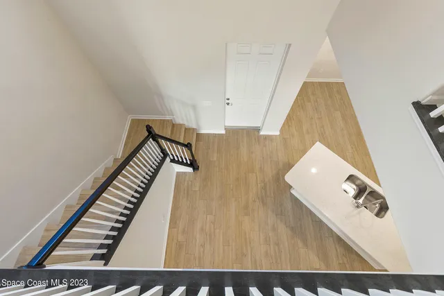 a bathroom with a granite countertop sink a toilet a mirror and bathtub