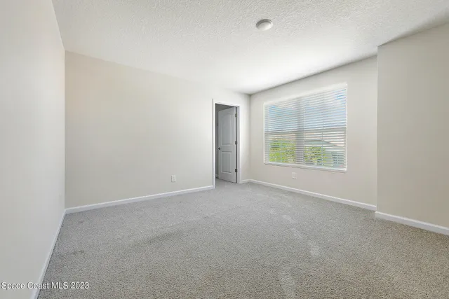 a view of an empty room and a window
