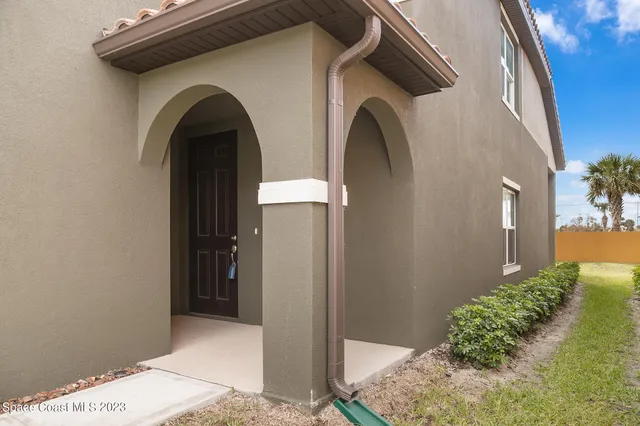 a view of a kitchen with a sink and refrigerator