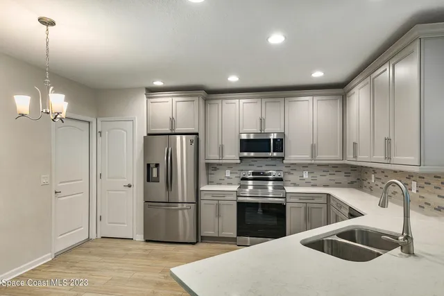 a kitchen with stainless steel appliances granite countertop a sink and cabinets