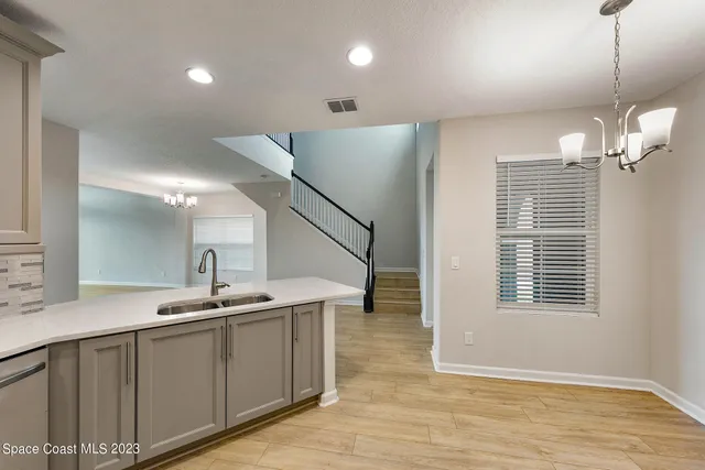 a view of kitchen and kitchen with wooden floor