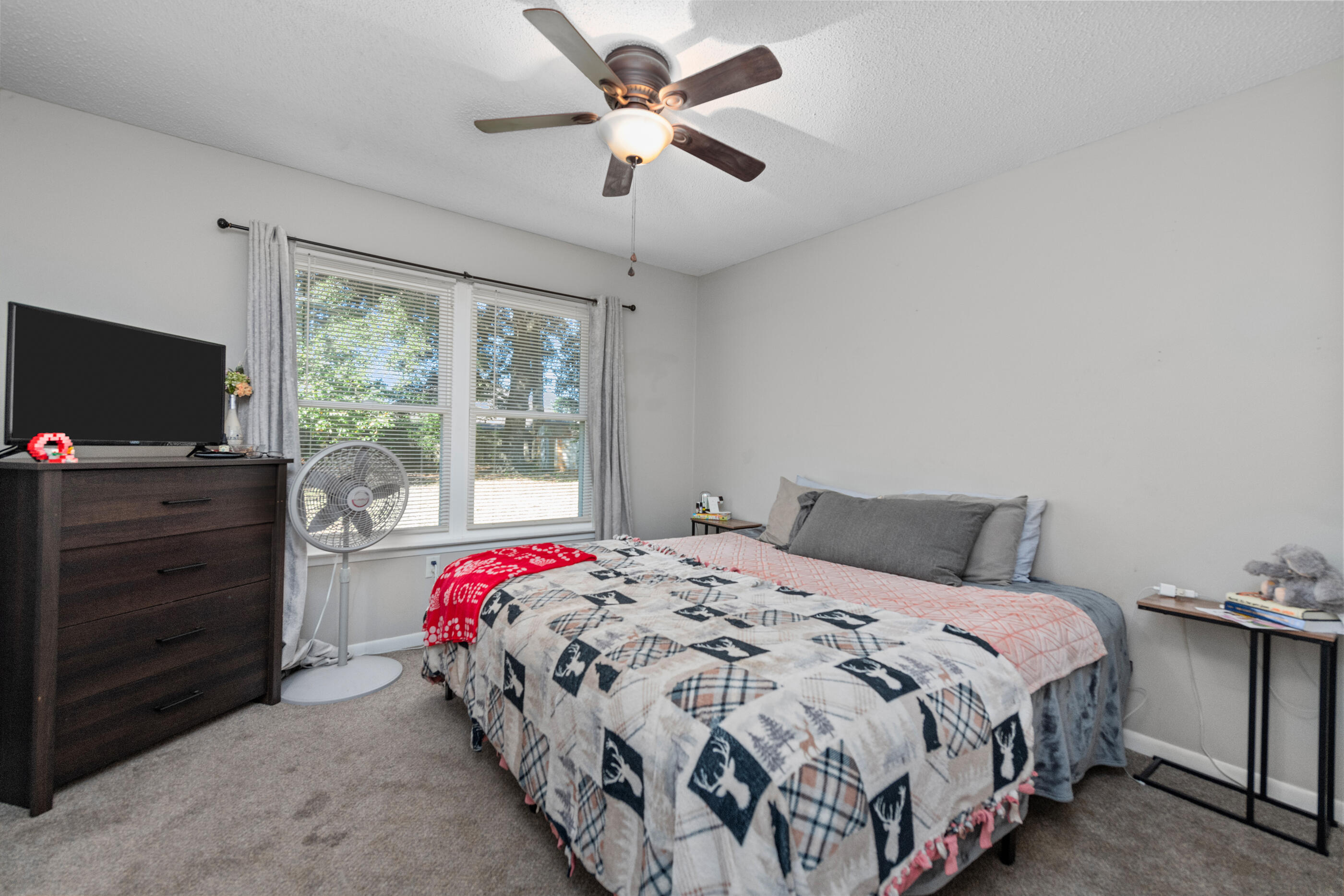 226 Springwood Circle Crestview, FL 32536 - Photo 12 of 27 a bedroom with a bed and a flat screen tv