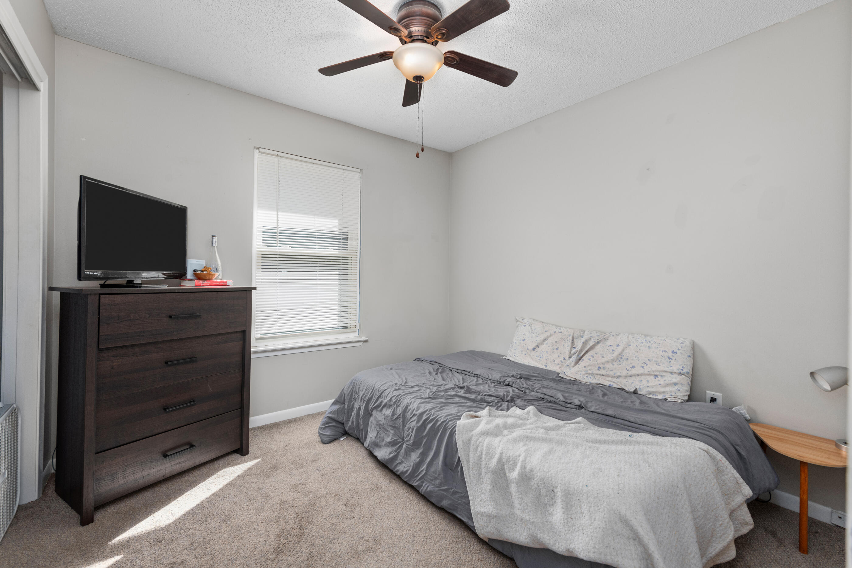 226 Springwood Circle Crestview, FL 32536 - Photo 13 of 27 a bedroom with a bed and a flat screen tv