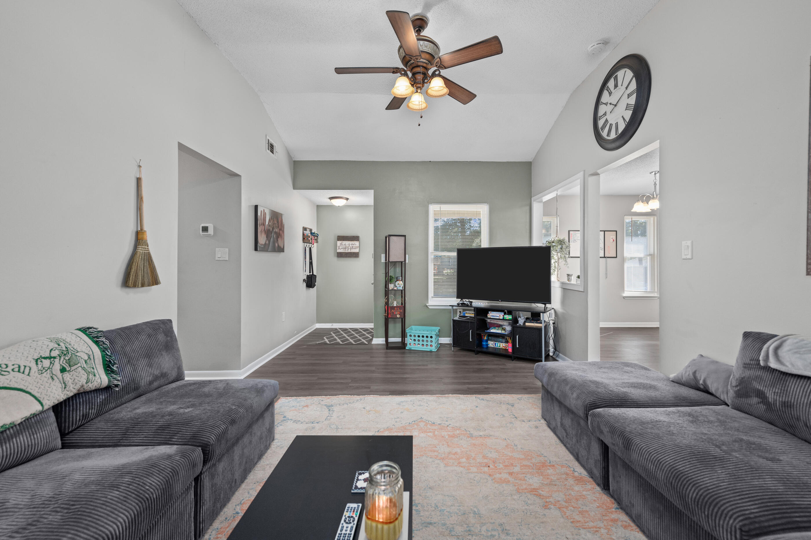 226 Springwood Circle Crestview, FL 32536 - Photo 6 of 27 a living room with furniture and a flat screen tv with wooden floor