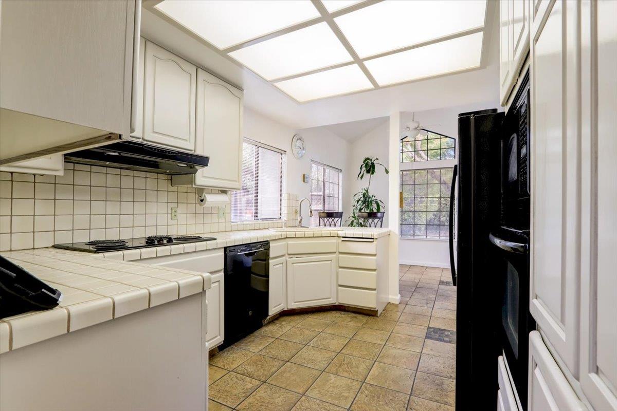 952 Corbel Common Fremont, CA 94539 - Photo 14 of 50 a kitchen with stainless steel appliances granite countertop a stove a sink and a refrigerator