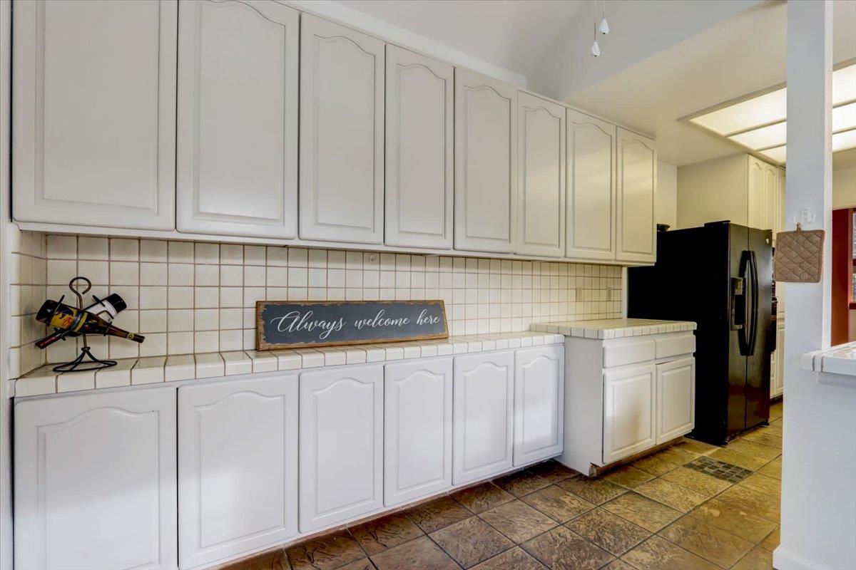 952 Corbel Common Fremont, CA 94539 - Photo 18 of 50 a kitchen with white cabinets and sink