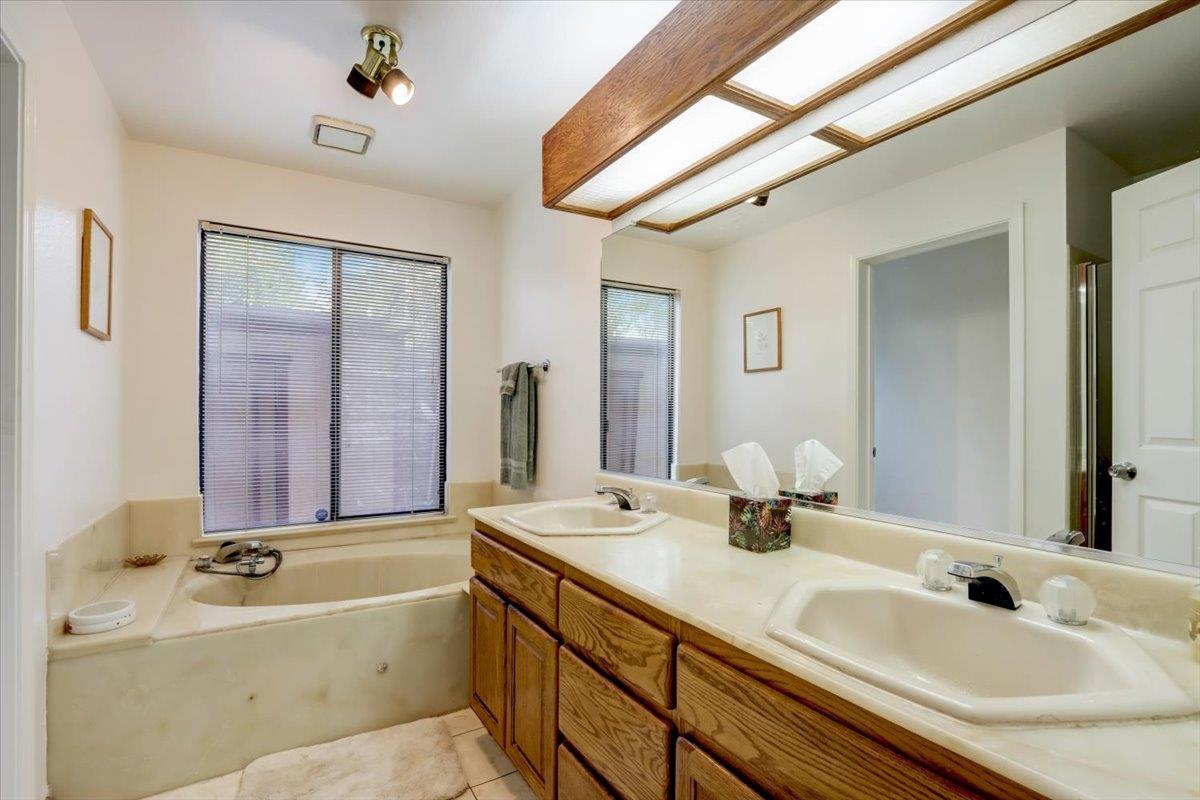 952 Corbel Common Fremont, CA 94539 - Photo 21 of 50 a bathroom with a tub sink and mirror