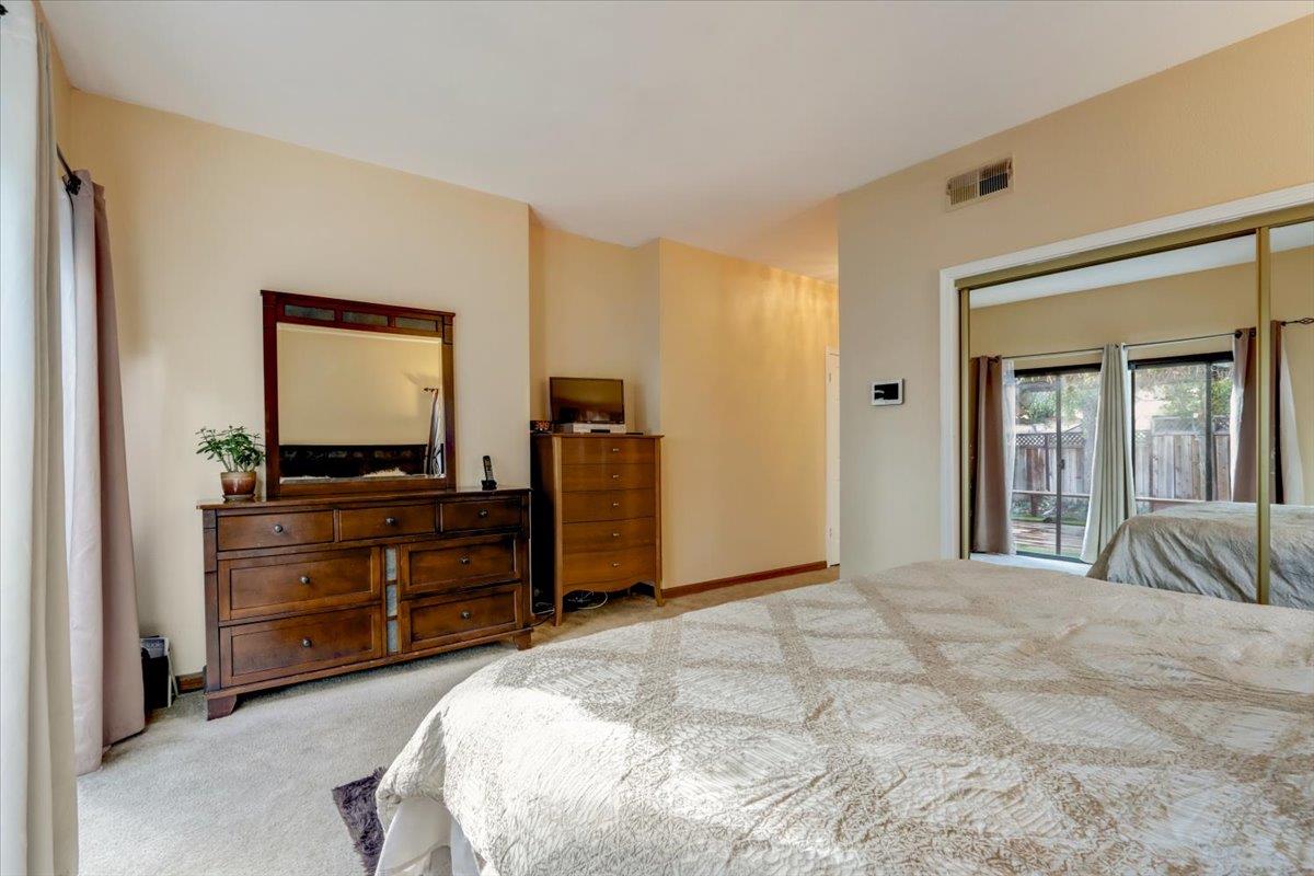 952 Corbel Common Fremont, CA 94539 - Photo 24 of 50 a bedroom with a bed and a dresser
