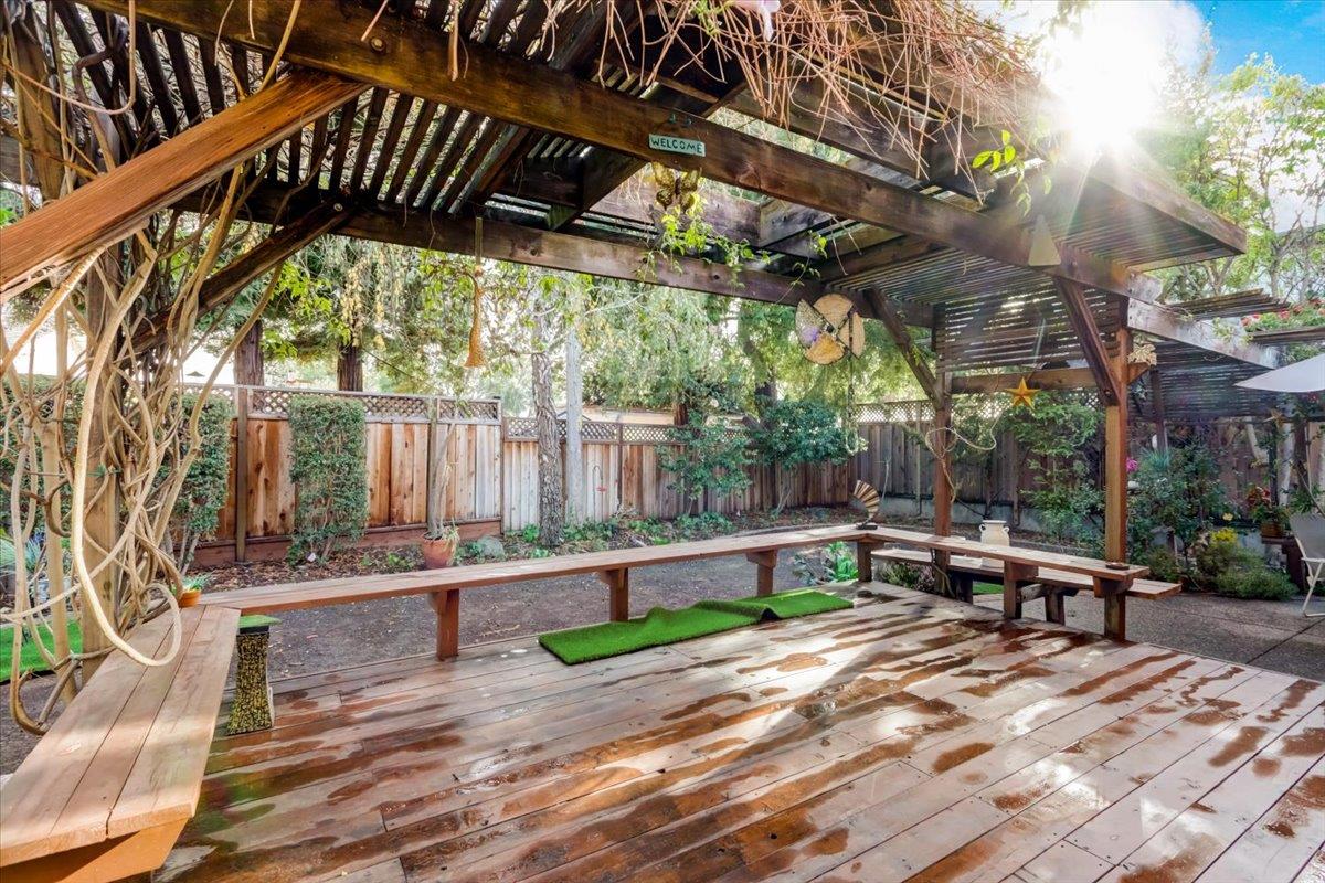 952 Corbel Common Fremont, CA 94539 - Photo 36 of 50 a view of backyard with a table and chairs under an umbrella with a barbeque