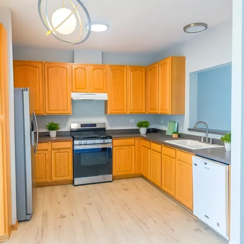 a kitchen with granite countertop a stove cabinets and sink