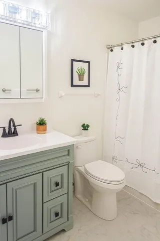 a bathroom with a sink a toilet and a mirror