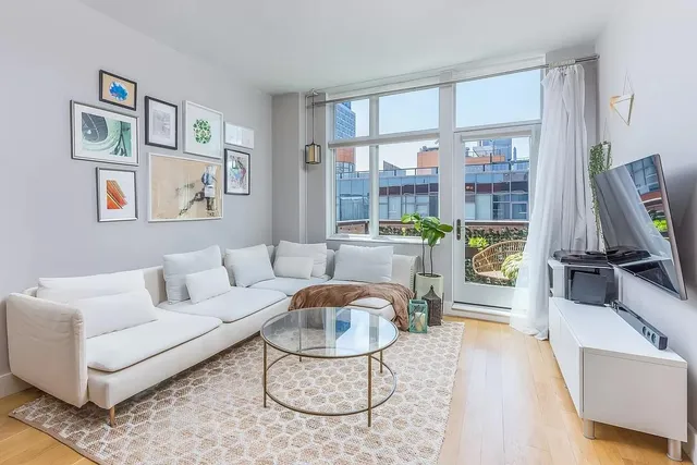 a living room with furniture a rug and a large window