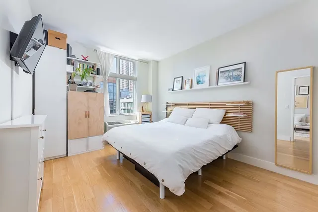 a bedroom with a bed closet and window