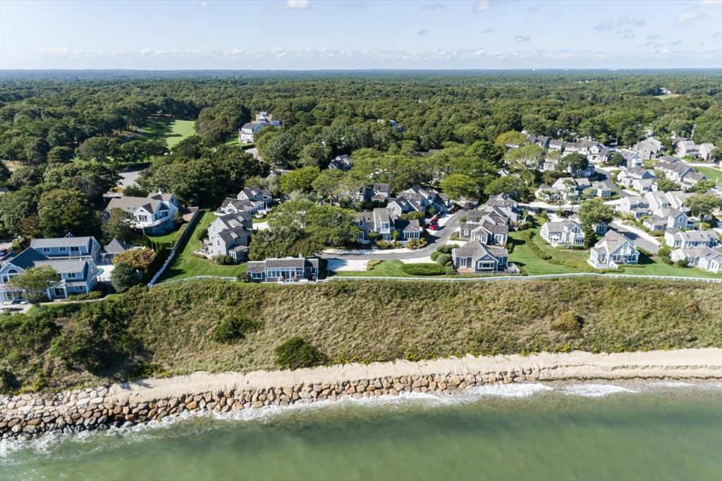 21 Milestone Way, Unit 620 Mashpee, MA 02649 - Photo 25 of 28 an aerial view of a houses with yard and lake view