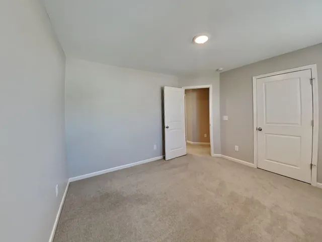 an empty room with closet area