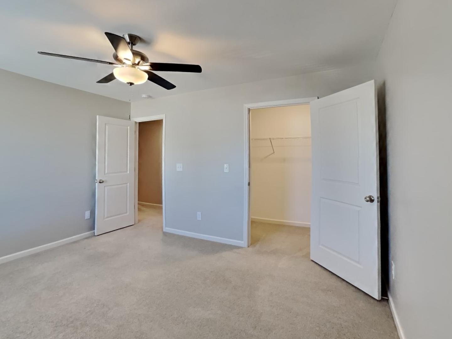 43 Wild Sage Circle Angier, NC 27501 - Photo 13 of 19 a view of an empty room with a chandelier fan