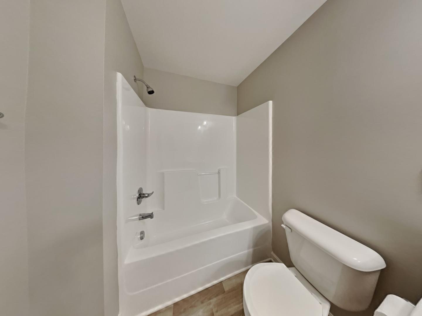 43 Wild Sage Circle Angier, NC 27501 - Photo 18 of 19 a bathroom with a toilet and a bathtub