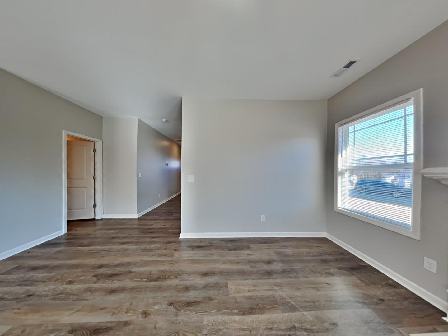 43 Wild Sage Circle Angier, NC 27501 - Photo 2 of 19 a view of an empty room with wooden floor and a window