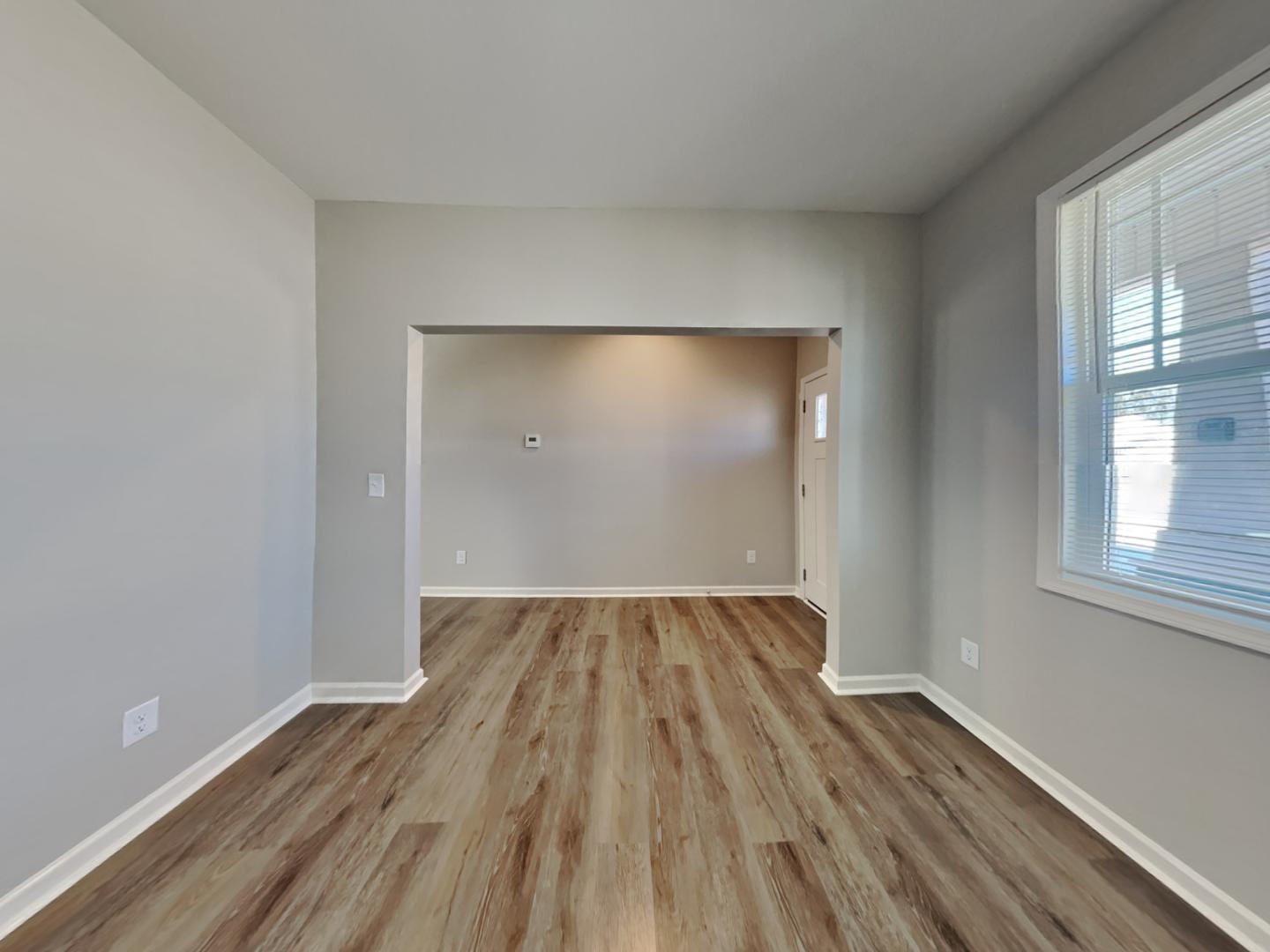 43 Wild Sage Circle Angier, NC 27501 - Photo 4 of 19 an empty room with wooden floor and windows