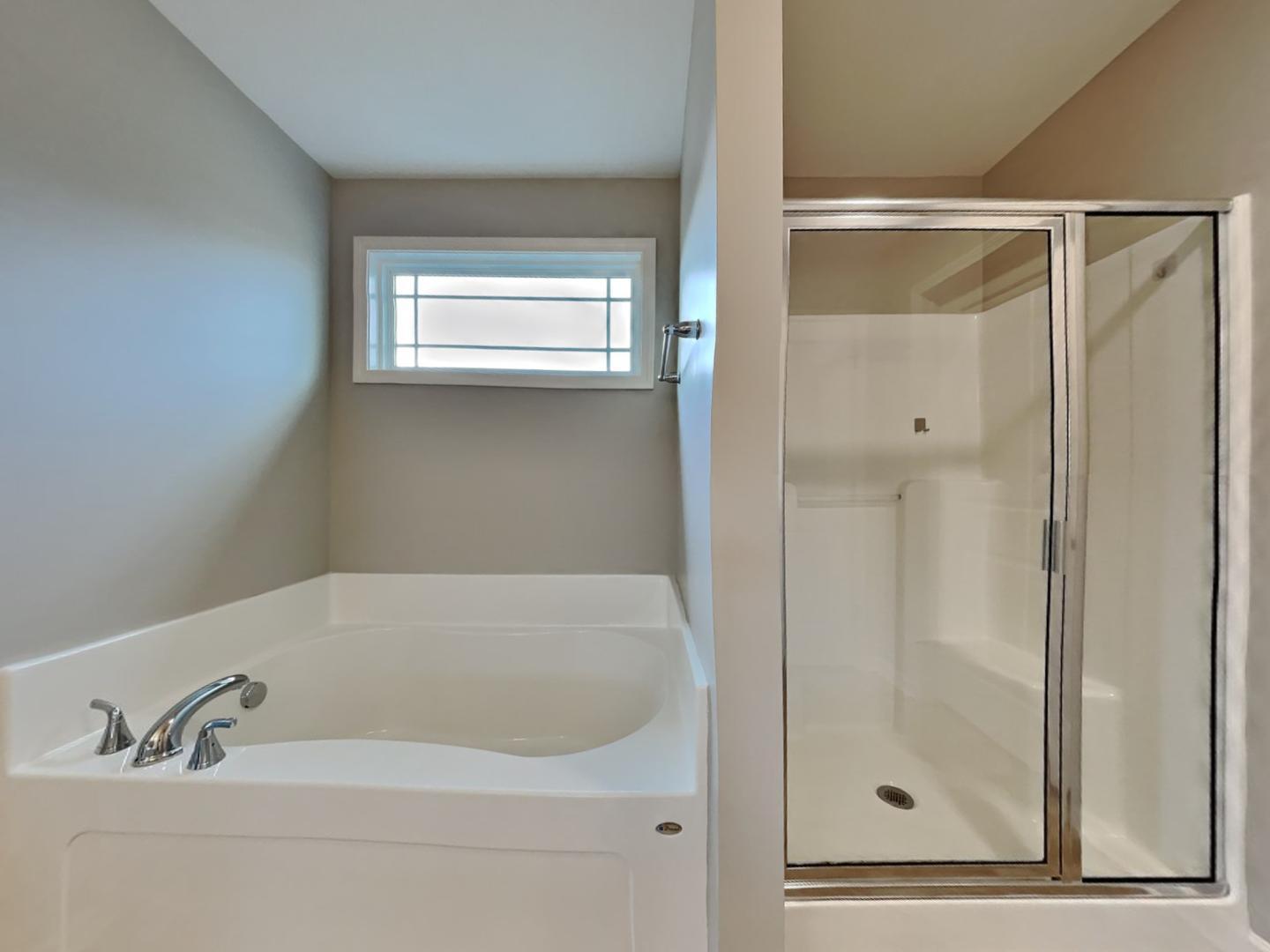 43 Wild Sage Circle Angier, NC 27501 - Photo 10 of 19 a bathroom with a bathtub and a shower
