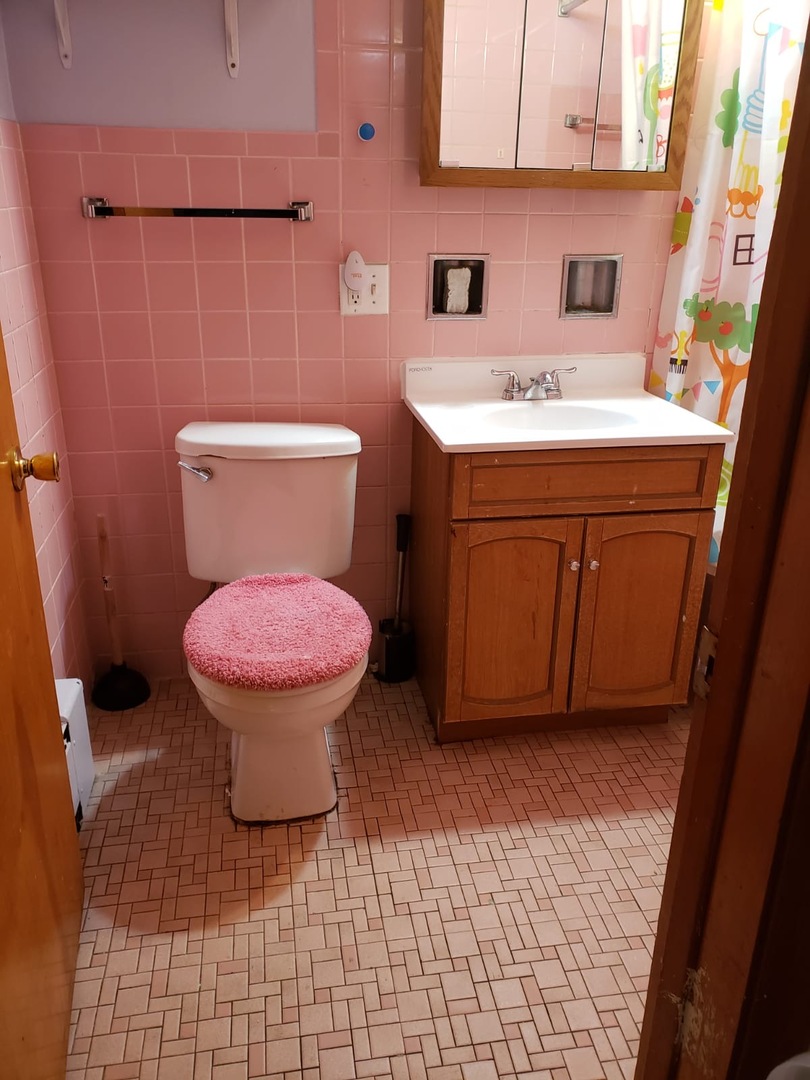 2000 West Arthur Avenue, Unit 2NW Chicago, IL 60645 - Photo 24 of 26 a bathroom with a sink toilet and a mirror
