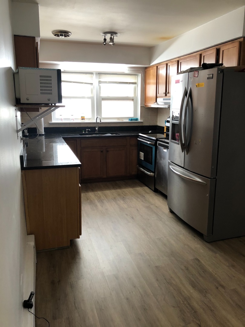 2000 West Arthur Avenue, Unit 2NW Chicago, IL 60645 - Photo 5 of 26 a kitchen with stainless steel appliances granite countertop a refrigerator a sink a stove and a refrigerator