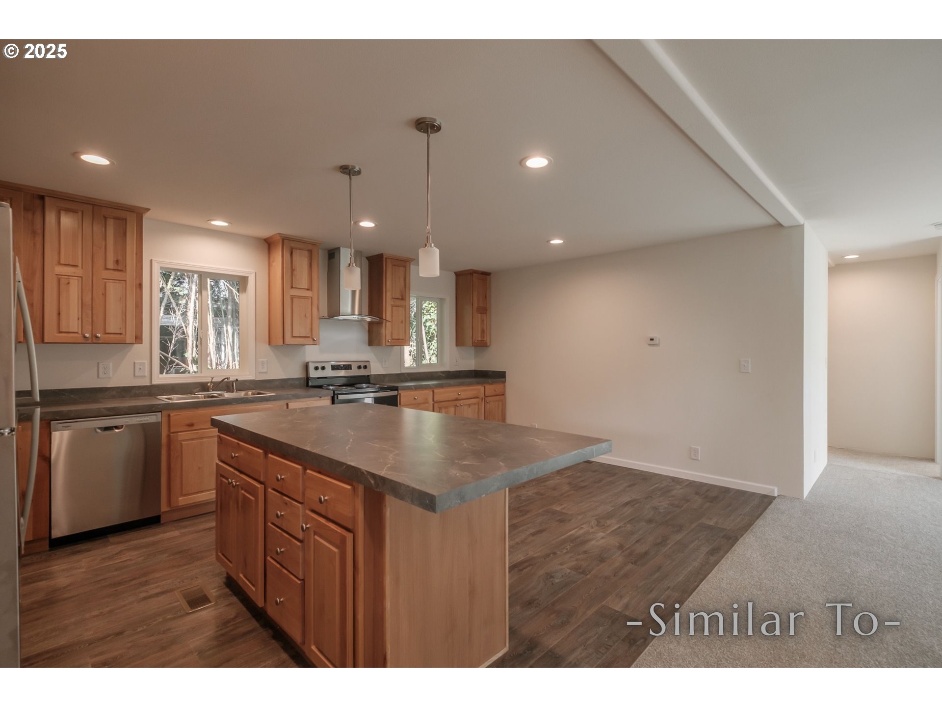 3223 Comber Court Northeast Salem, OR 97305 - Photo 9 of 39 a kitchen with kitchen island sink stove and cabinets