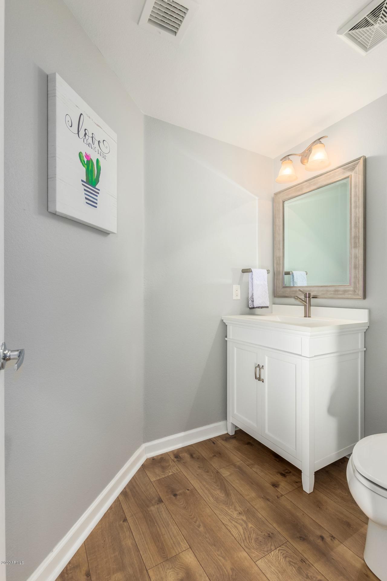 280 South Evergreen Road, Unit 1245 Tempe, AZ 85288 - Photo 1 of 28 a bathroom with a toilet sink and mirror