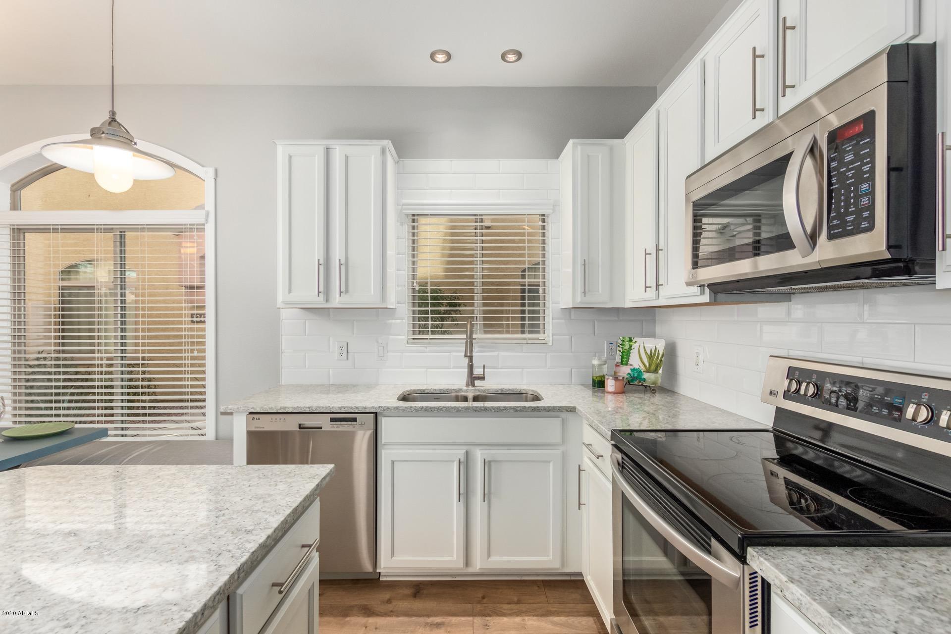 280 South Evergreen Road, Unit 1245 Tempe, AZ 85288 - Photo 11 of 28 a kitchen with stainless steel appliances granite countertop a sink stove and cabinets