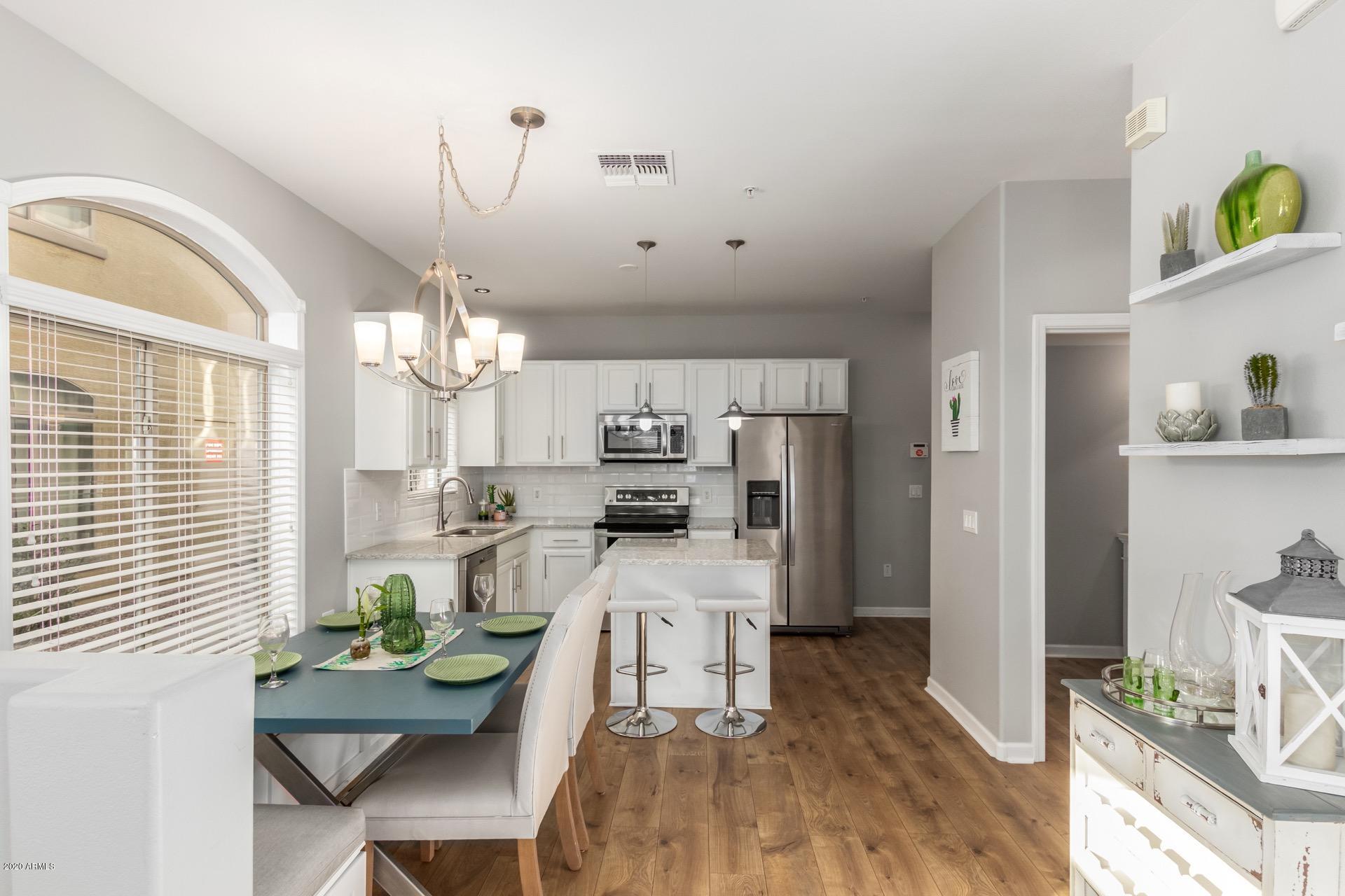 280 South Evergreen Road, Unit 1245 Tempe, AZ 85288 - Photo 6 of 28 a living room with kitchen island furniture and a chandelier