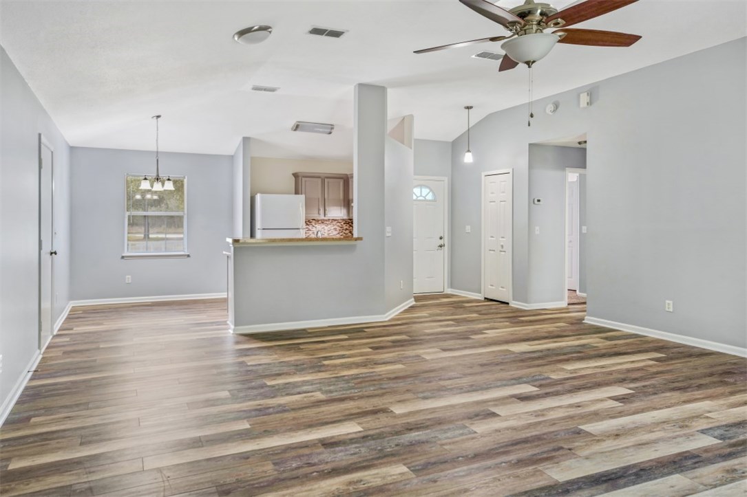 96438 Chester Road Yulee, FL 32097 - Photo 2 of 25 a view of a livingroom with wooden floor and a ceiling fan