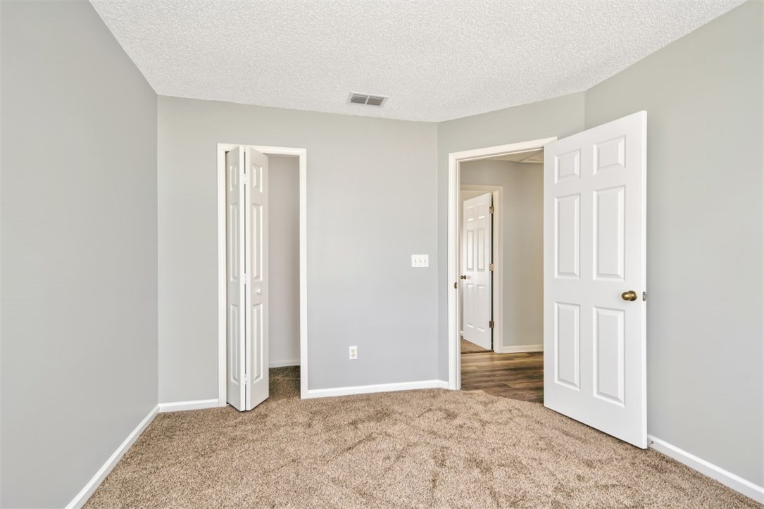 96438 Chester Road Yulee, FL 32097 - Photo 21 of 25 an empty room with closet and windows