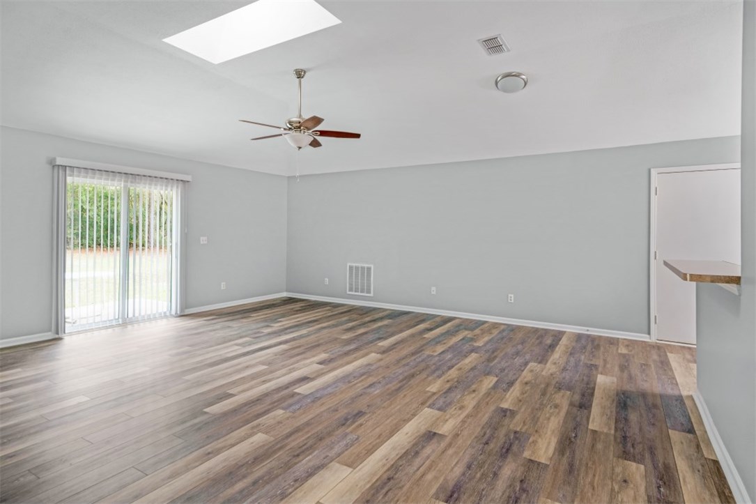 96438 Chester Road Yulee, FL 32097 - Photo 3 of 25 wooden floor in an empty room with a window