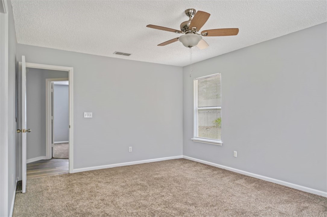 96438 Chester Road Yulee, FL 32097 - Photo 6 of 25 an empty room with a window and a fan