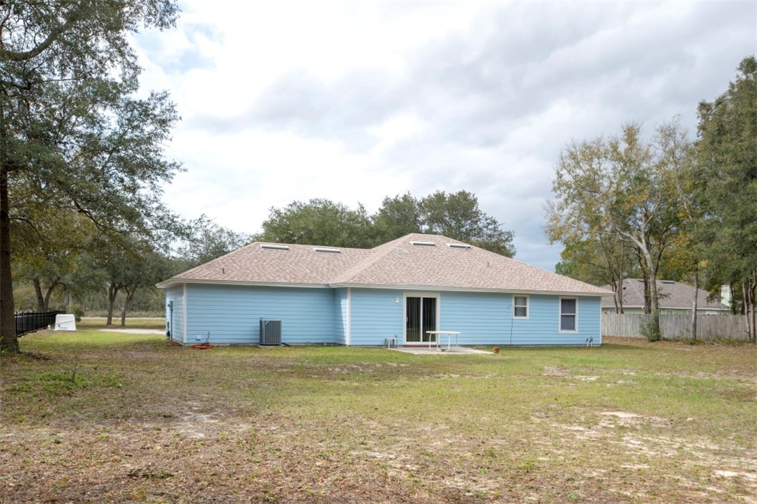 96438 Chester Road Yulee, FL 32097 - Photo 7 of 25 a front view of a house with a garden