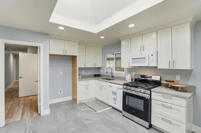 a kitchen with a refrigerator and a stove top oven
