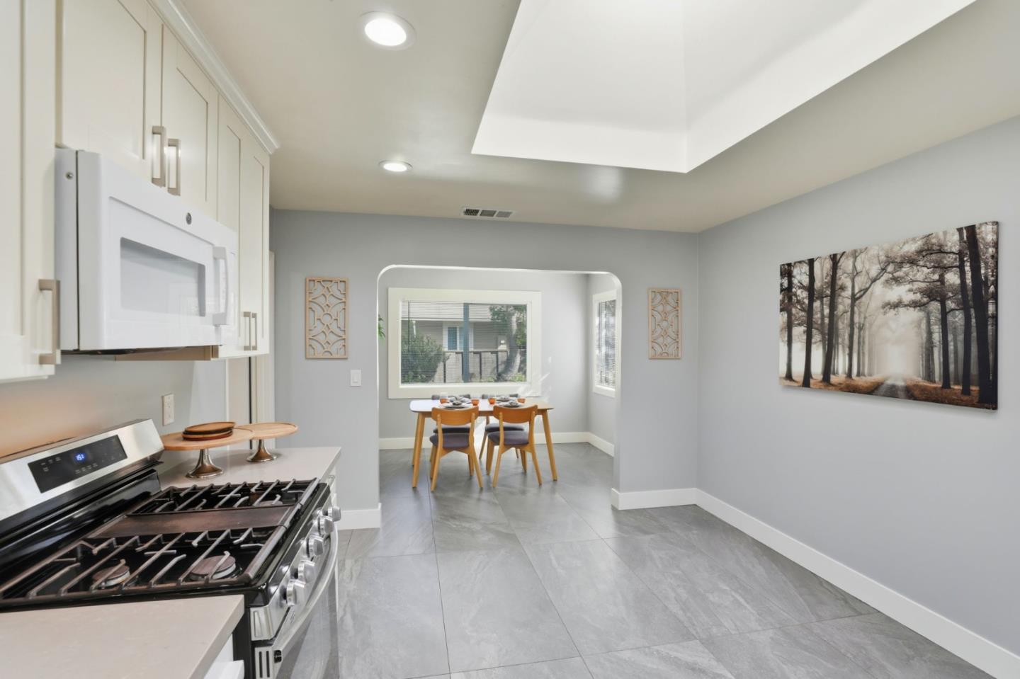 790 Shore Road Hollister, CA 95023 - Photo 16 of 70 a kitchen with stainless steel appliances granite countertop a stove top oven a sink a dining table and chairs with wooden floor