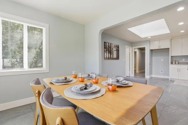 an empty room with a window and ceiling fan