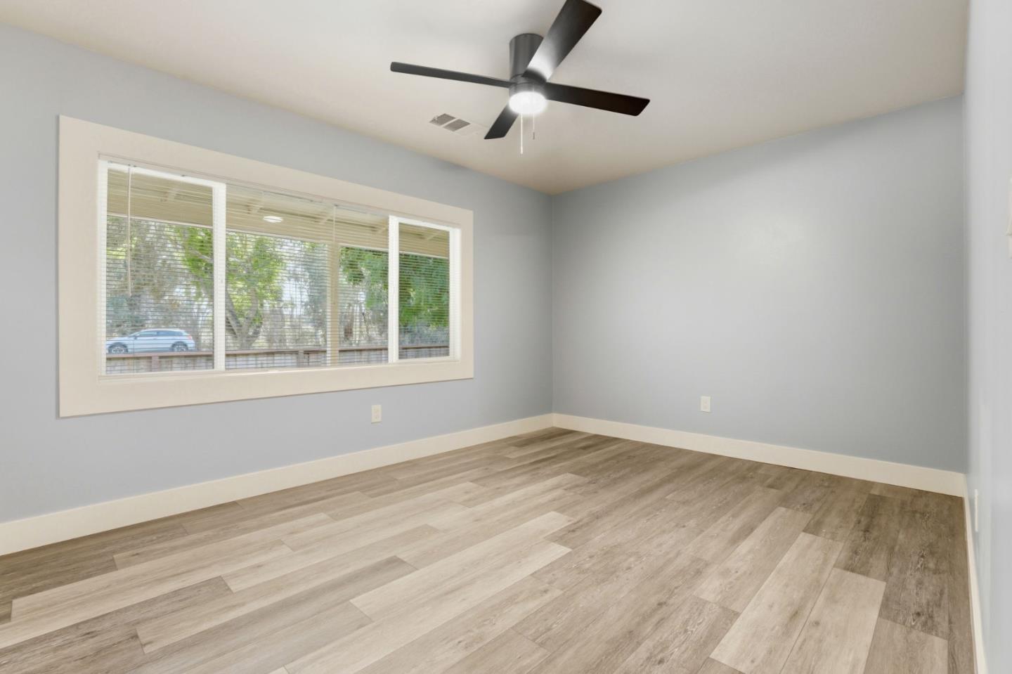 790 Shore Road Hollister, CA 95023 - Photo 19 of 70 a view of an empty room with wooden floor and a window