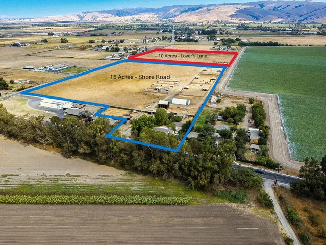 an aerial view of a house with a garden and lake view