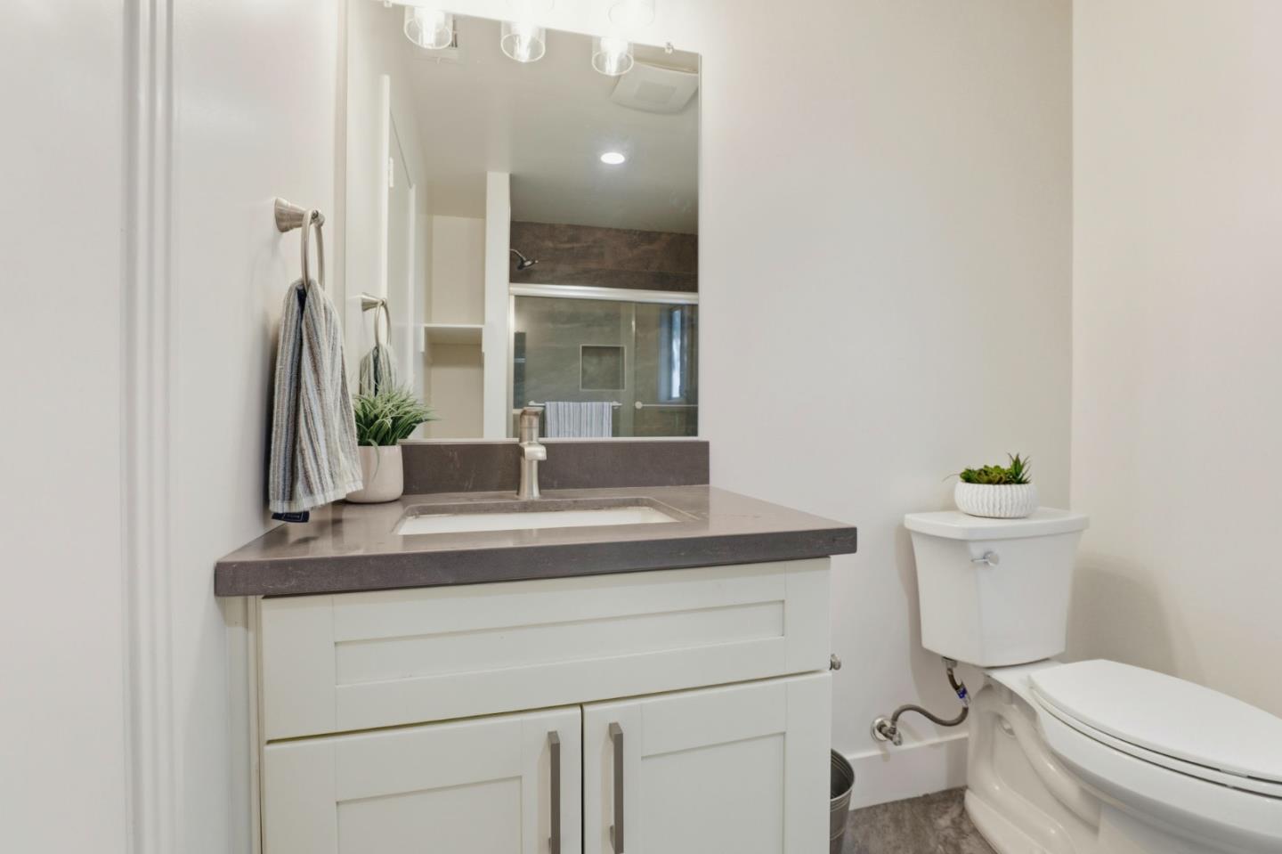 790 Shore Road Hollister, CA 95023 - Photo 26 of 70 a bathroom with a toilet a sink and mirror