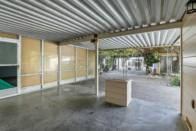 an aerial view of a house with a garden and lake view