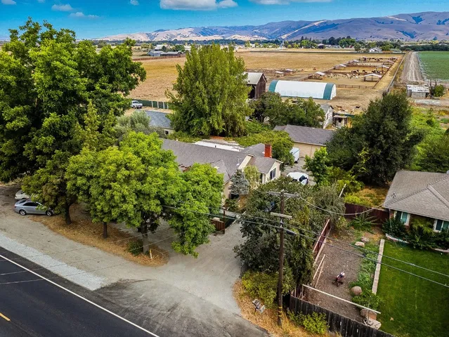 a view of a swimming pool with an outdoor seating and a yard