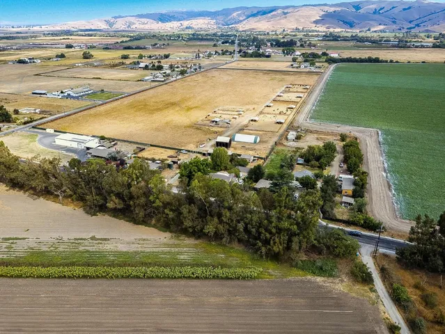 an aerial view of ocean with residential house with outdoor space and seating