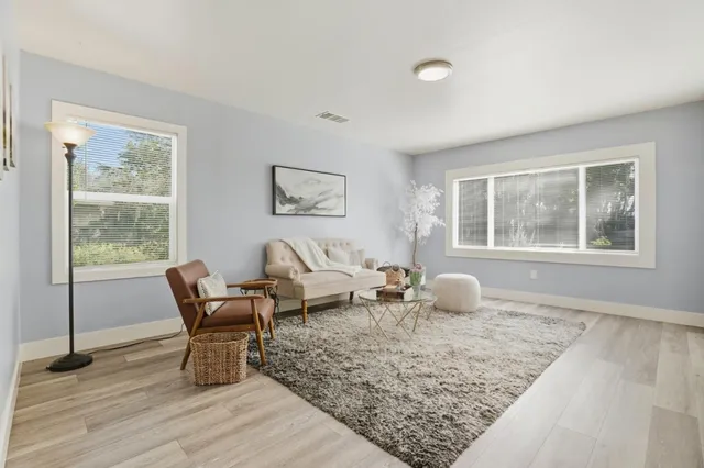 a living room with furniture and wooden floor