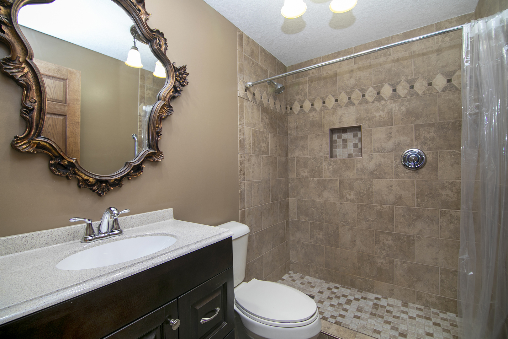 1173 Cecil Drive Kankakee, IL 60901 - Photo 11 of 32 a bathroom with a sink a toilet and shower