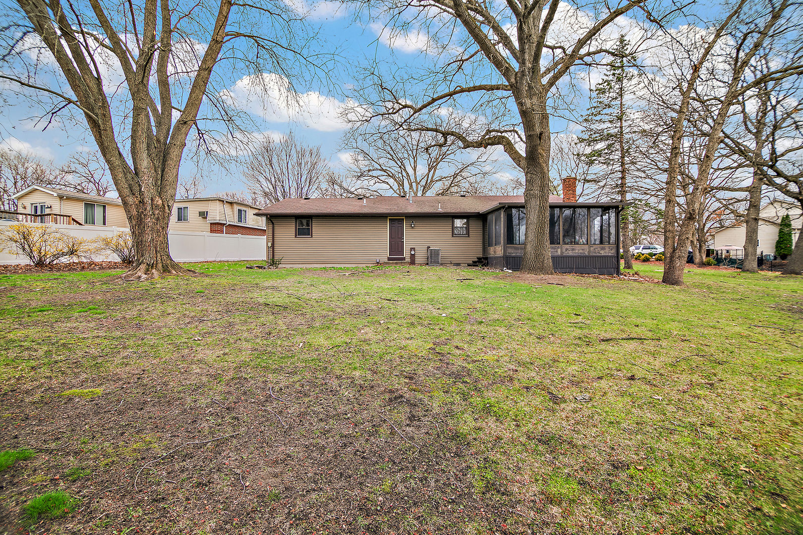 1173 Cecil Drive Kankakee, IL 60901 - Photo 17 of 32 a white house that has a tree in front of it